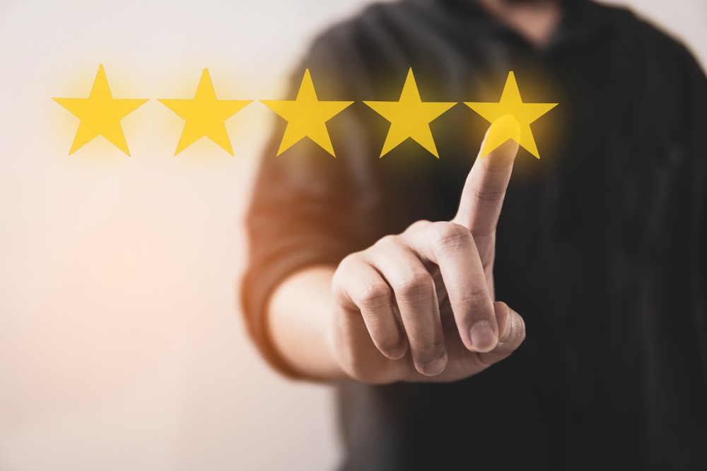 Customer review good rating concept hand pressing five star on visual screen and positive customer feedback testimonial